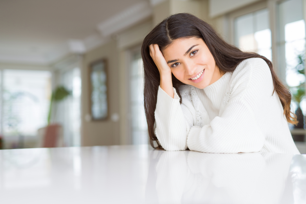 Cosmetic Dentistry for the Santa Cruz Community Beautiful brunette woman smiling cheerful with big smile, looking positive and happy with crossed arms