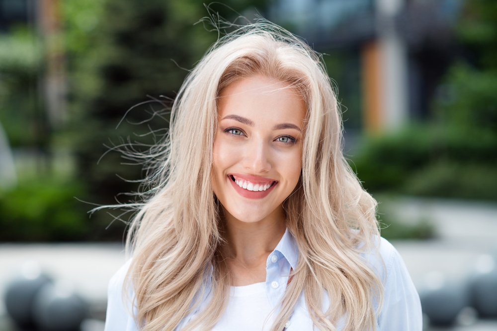 Confident Smiles from Dental Care in Scotts Valley Portrait of positive adorable cheerful woman walking in park sunny spring weather outside