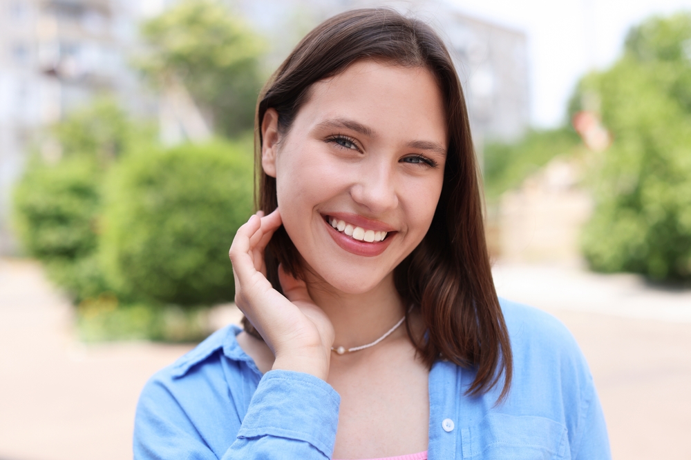 Confident Smile After Preventive Dental Care Smiling woman outdoors representing confidence after preventive dental care in Scotts Valley, CA