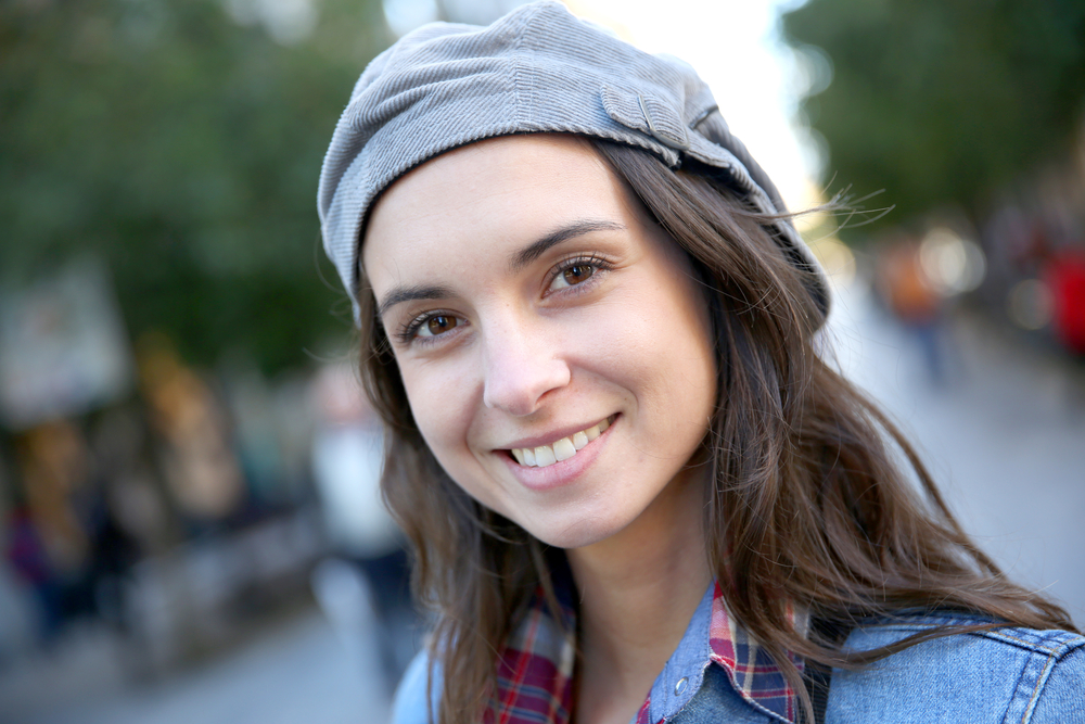 Scotts Valley Dental Patient Portrait of smiling woman in town wearing hat