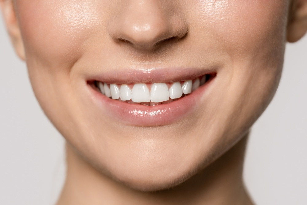 Professional Dental Care Results in Scotts Valley Smiling woman shows her white teeth with natural light in a simple background during a close-up shot
