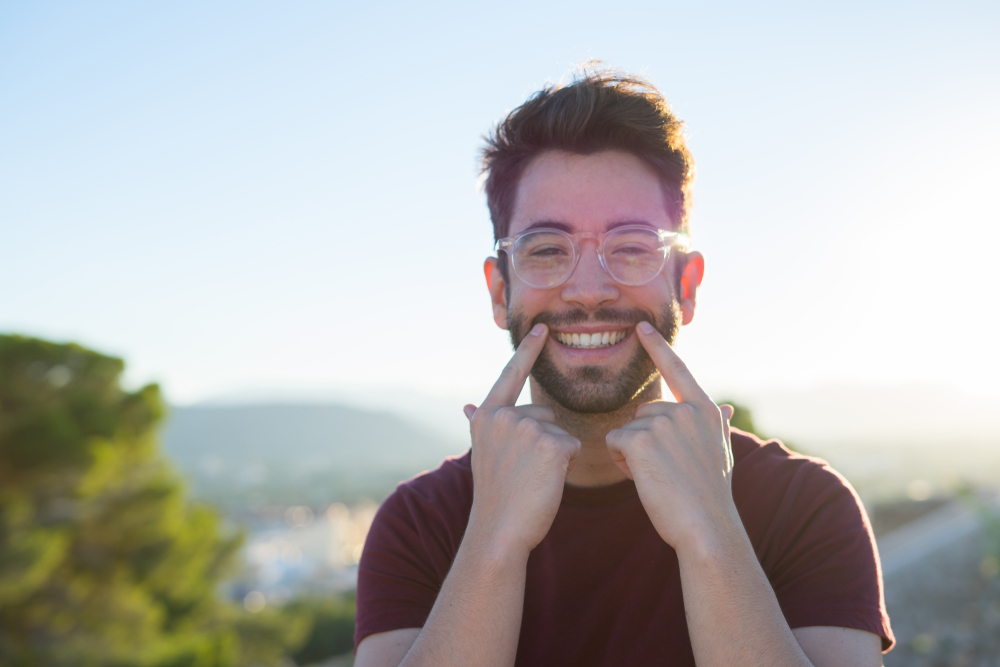 young man doing smile gesture